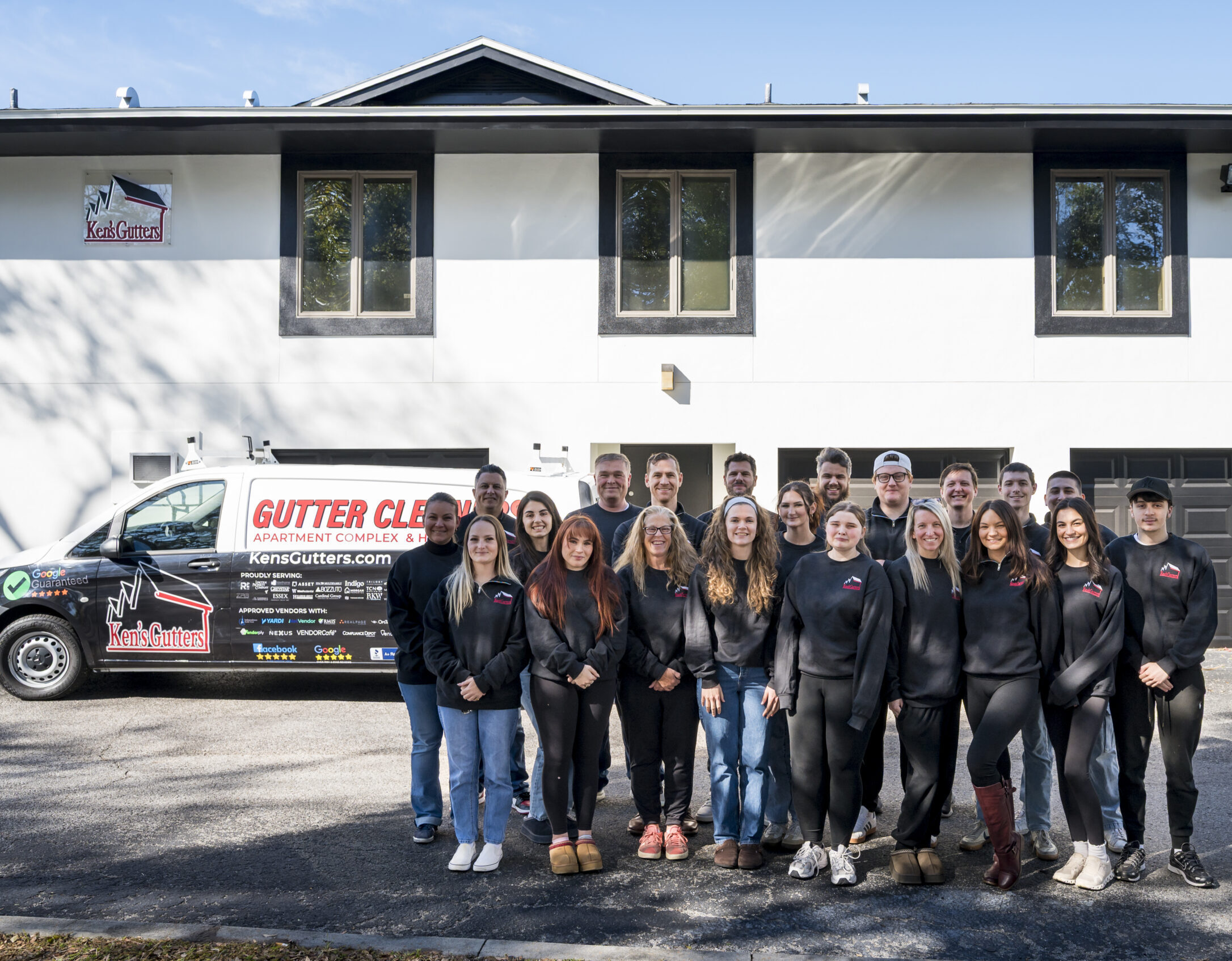 A photo with the whole Ken's Gutters team outside their office building in Florida.