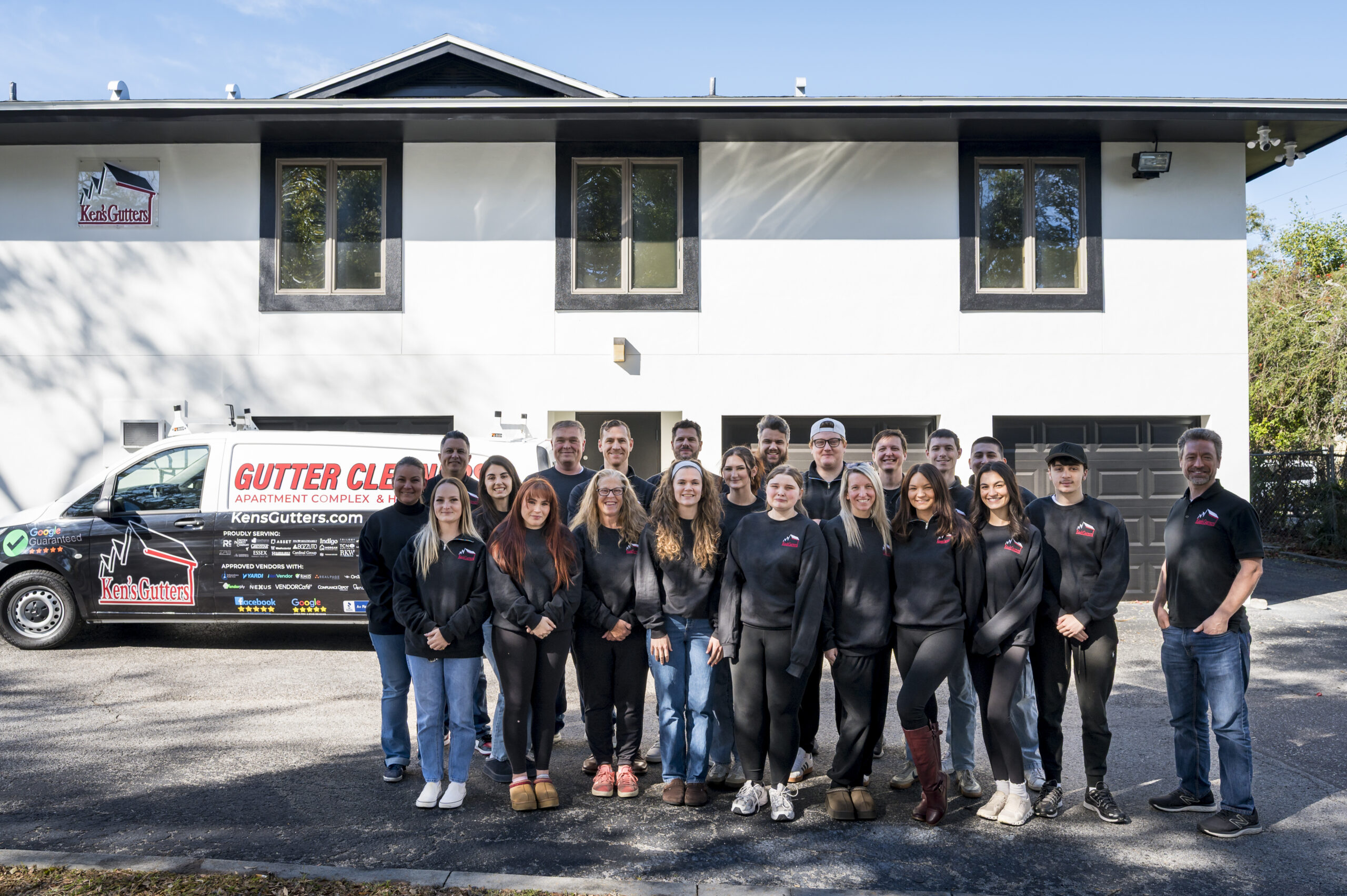 A photo with the whole Ken's Gutters team outside their office building in Florida.