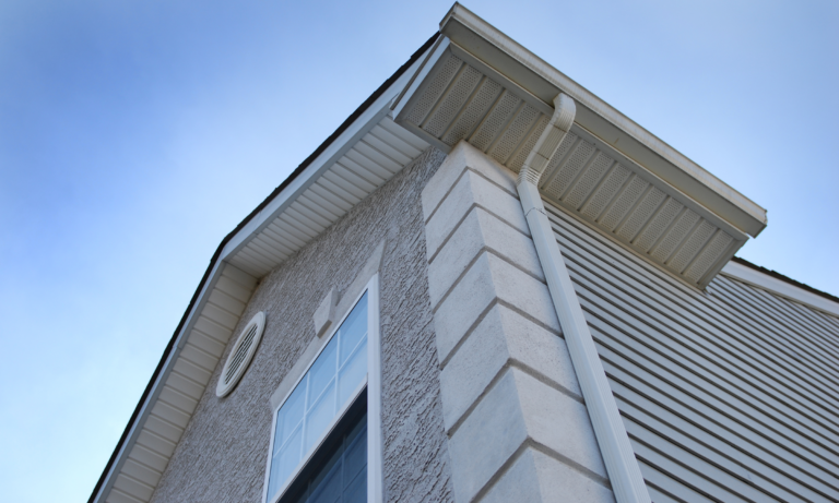 White church building gutter and downspout cleaning.