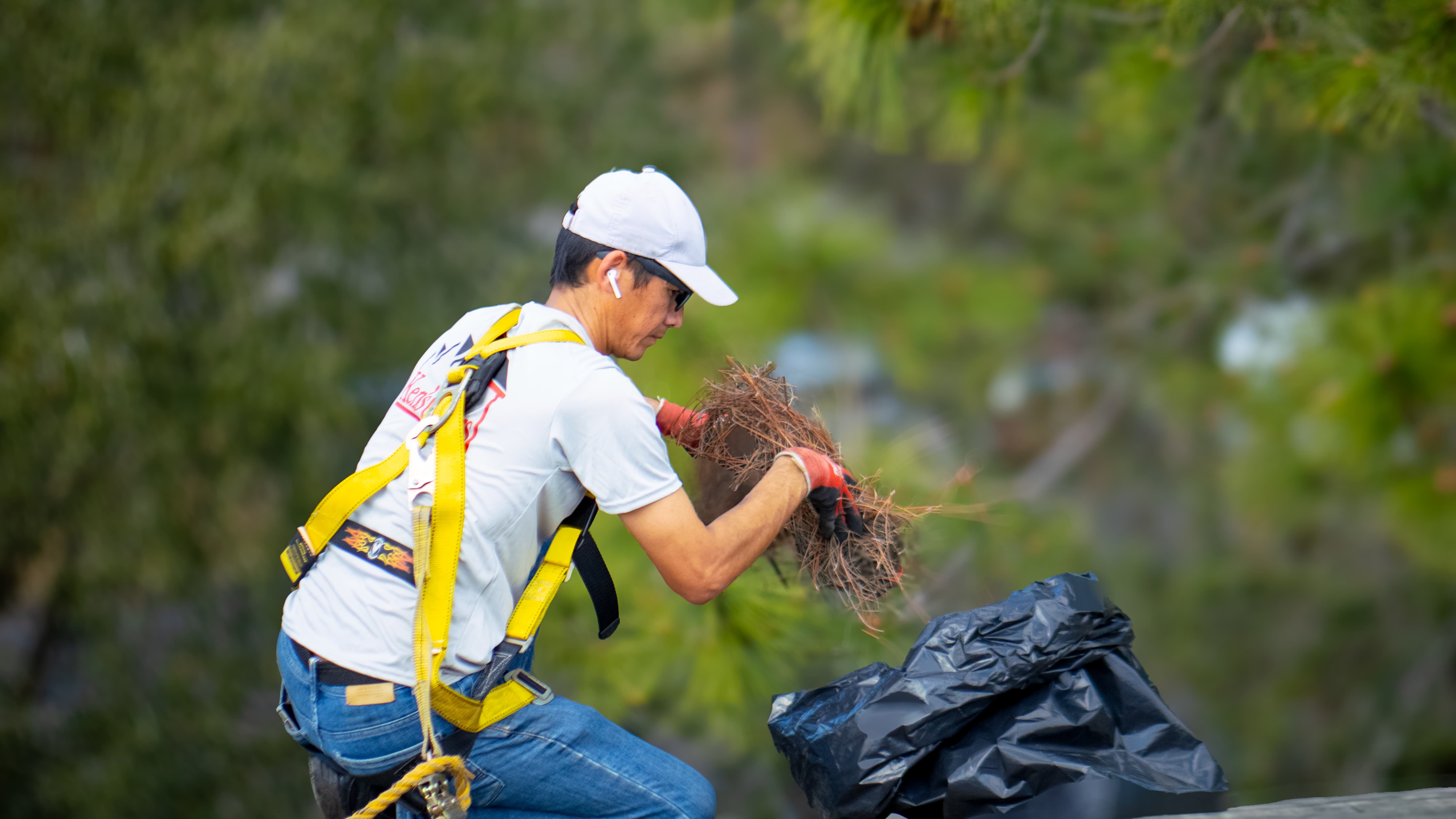 A Ken's Gutters gutter cleaner handling scheduled gutter cleaning maintenance.