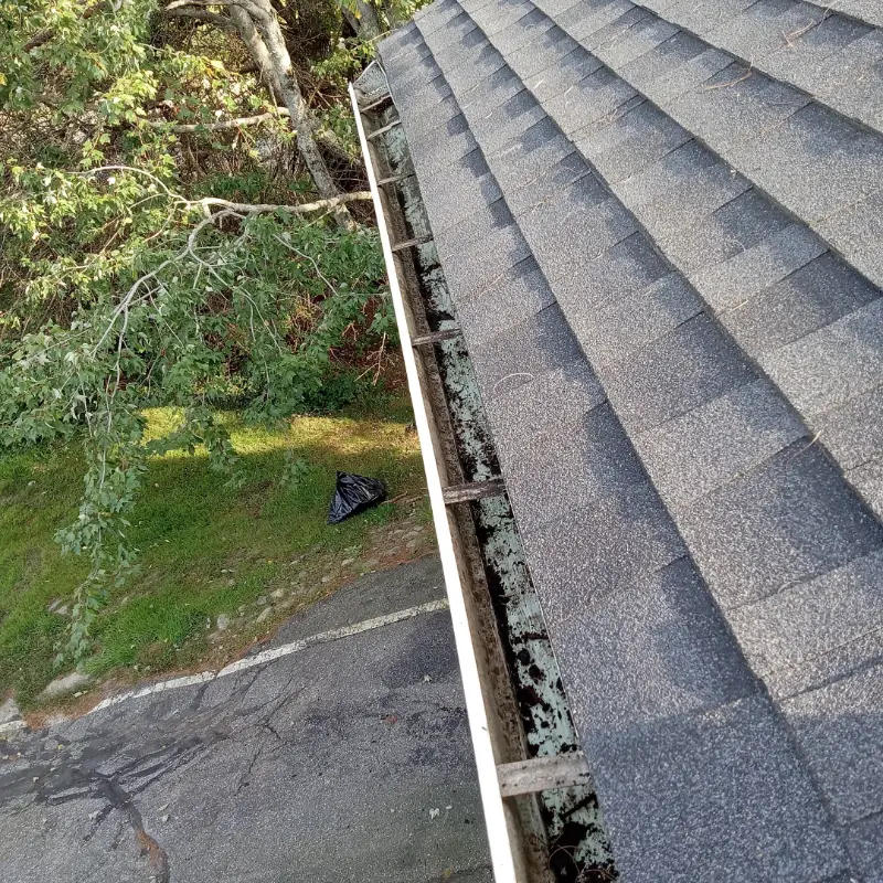 The same gutter run cleared and flushed after service