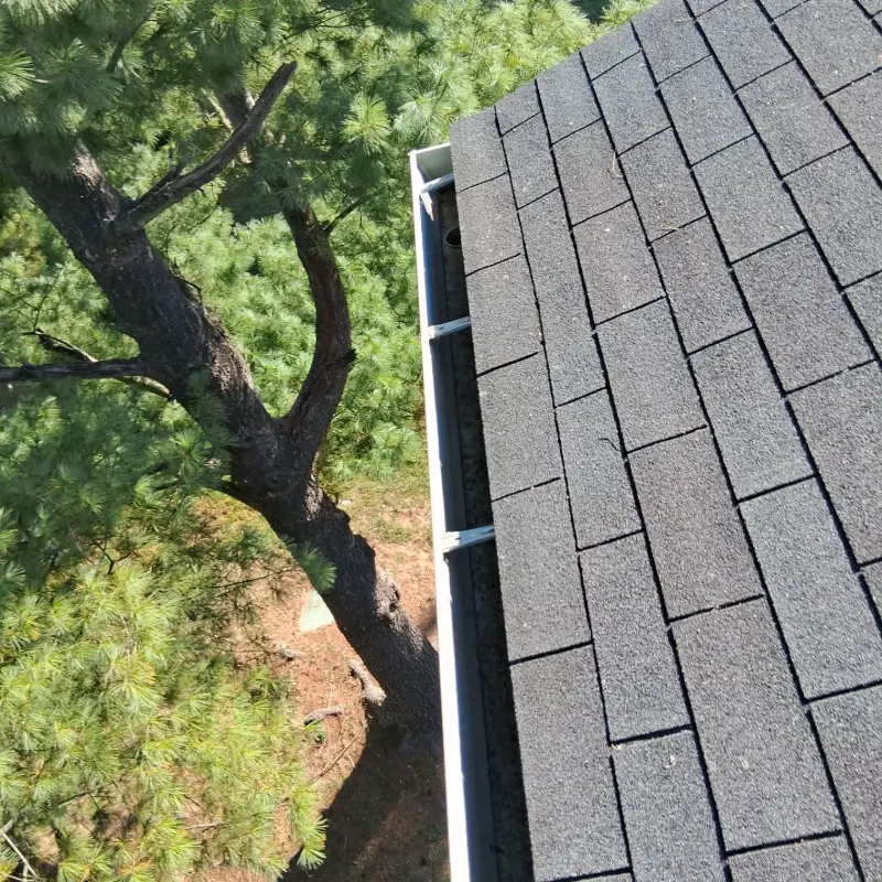 The same gutter run cleared and flushed after service