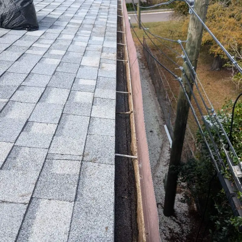 The same gutter run cleared and flushed after service